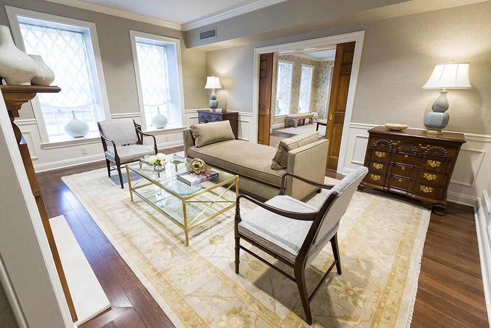 A living room filled with furniture and a rug