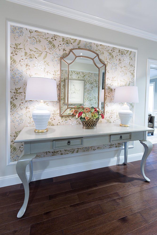 A table with two lamps and a vase of flowers on it