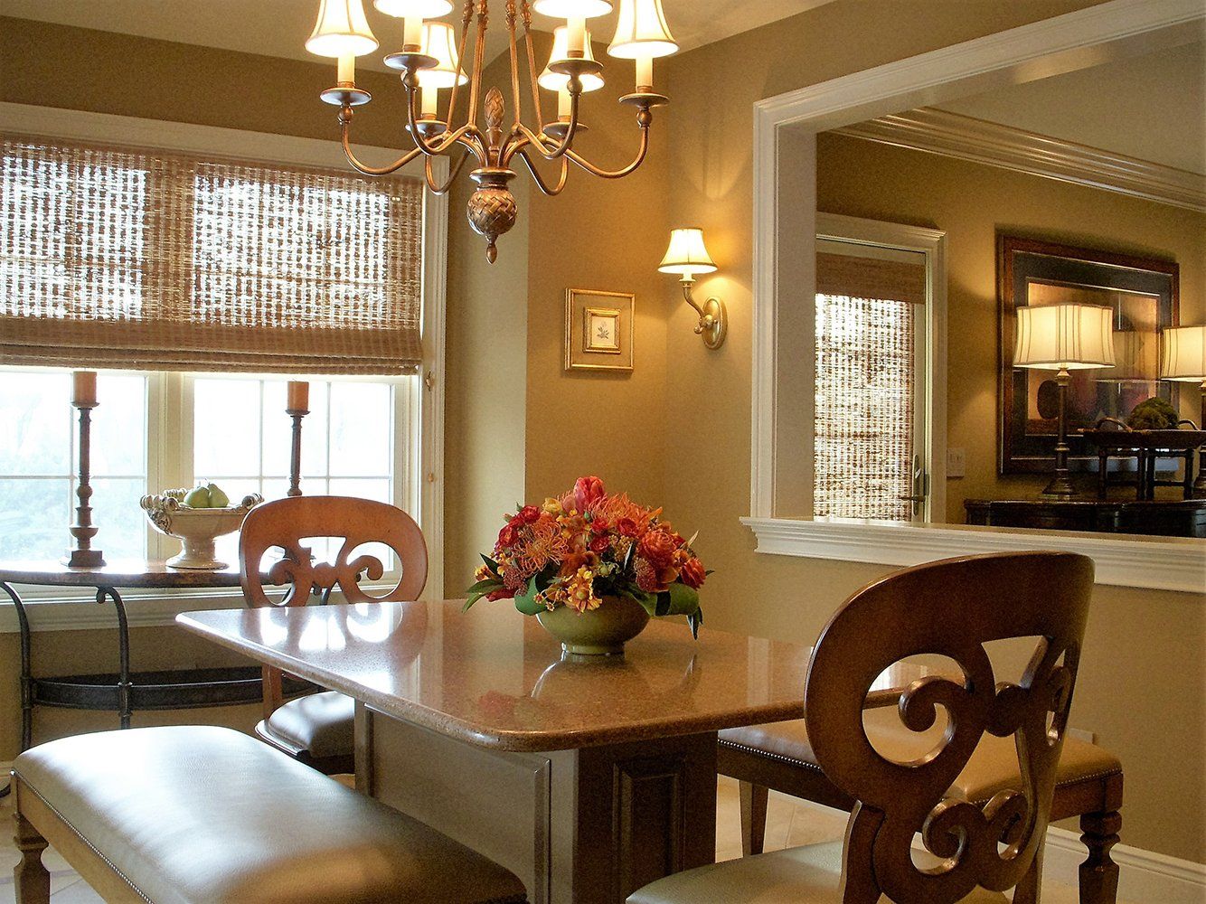 A dining room table with a vase of flowers on it