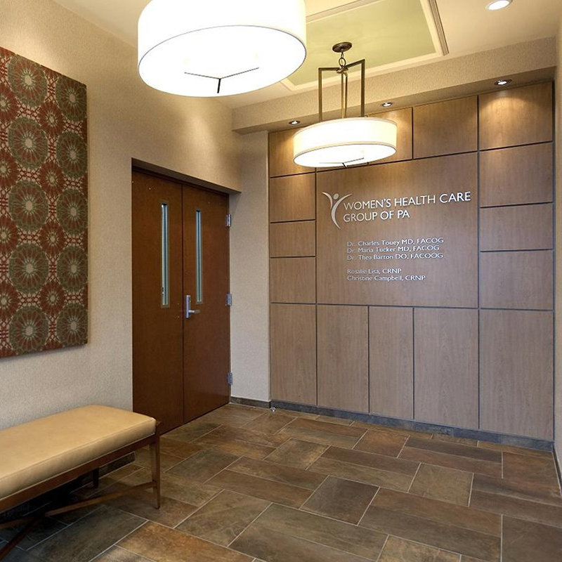 A hallway with a bench and a sign that says ' ymca health care ' on it