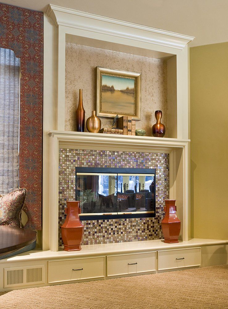 A living room with a fireplace and a painting on the wall