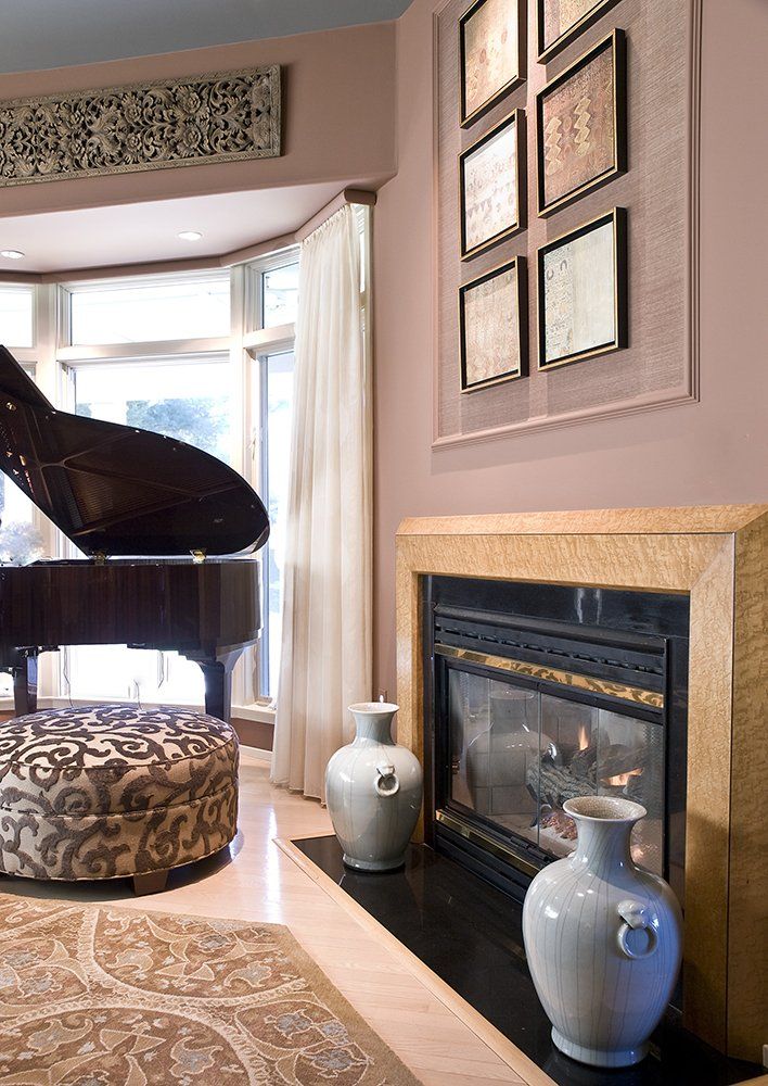 A living room with a fireplace and a piano