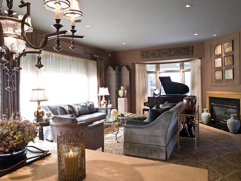 A living room with a piano and a fireplace