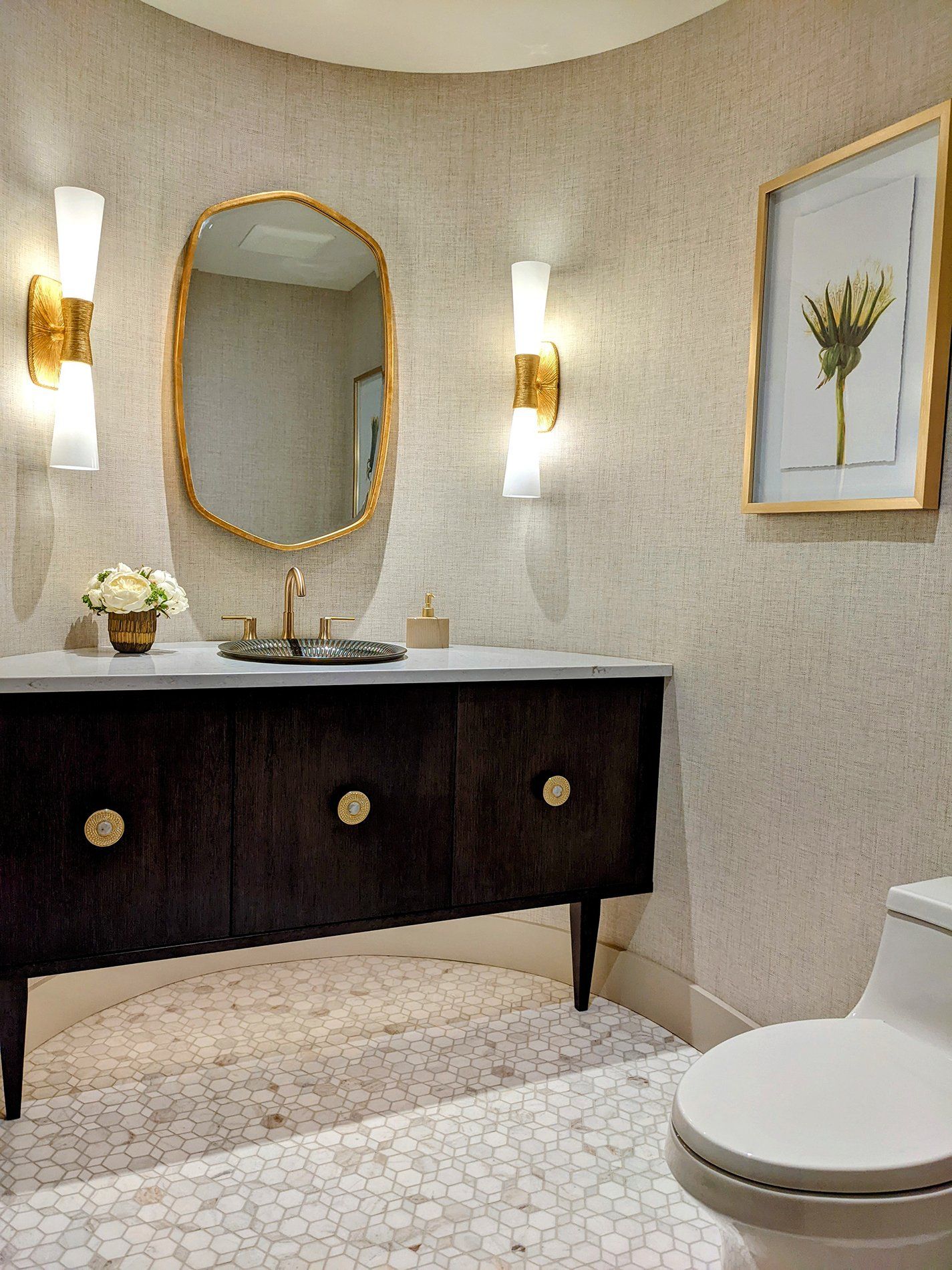 A bathroom with a toilet a sink and a mirror