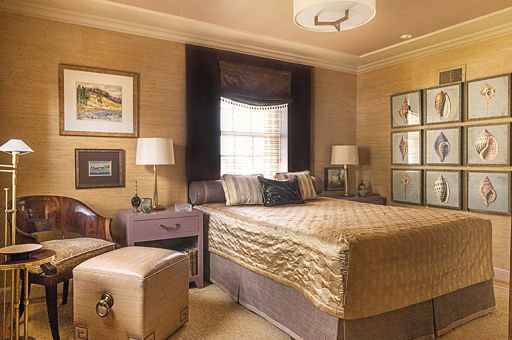 A bedroom with a large bed and lots of pictures on the wall