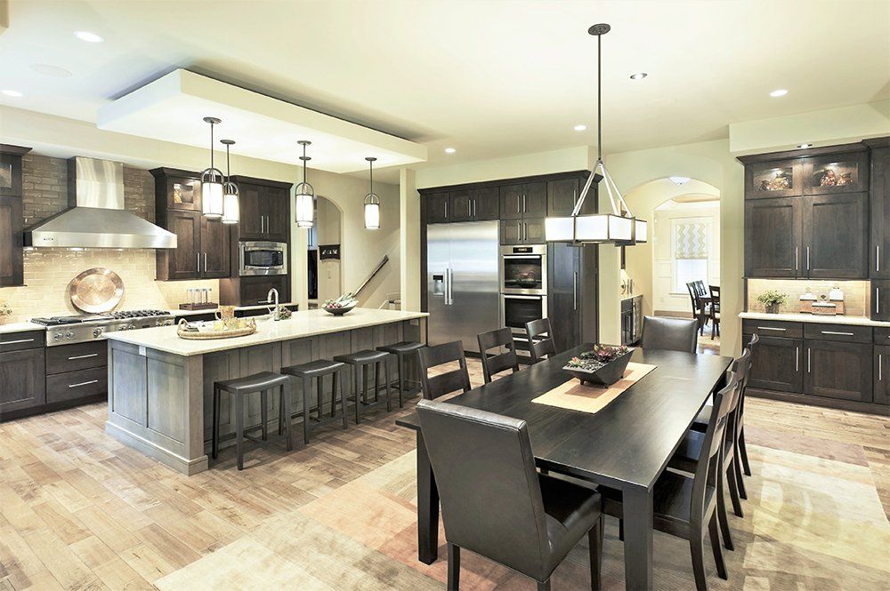 A large kitchen with a large table and chairs