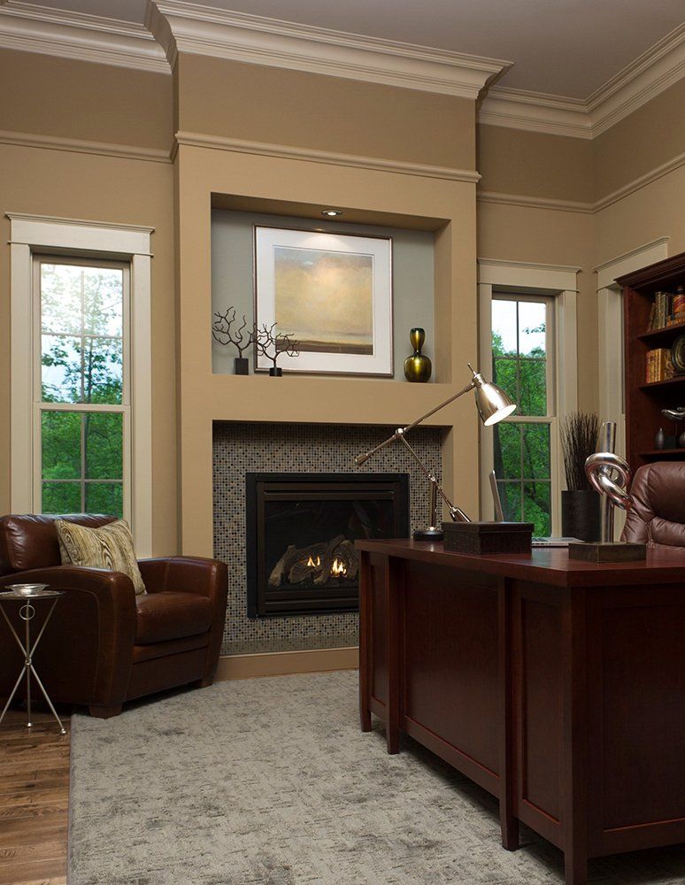 A living room with a fireplace and two chairs