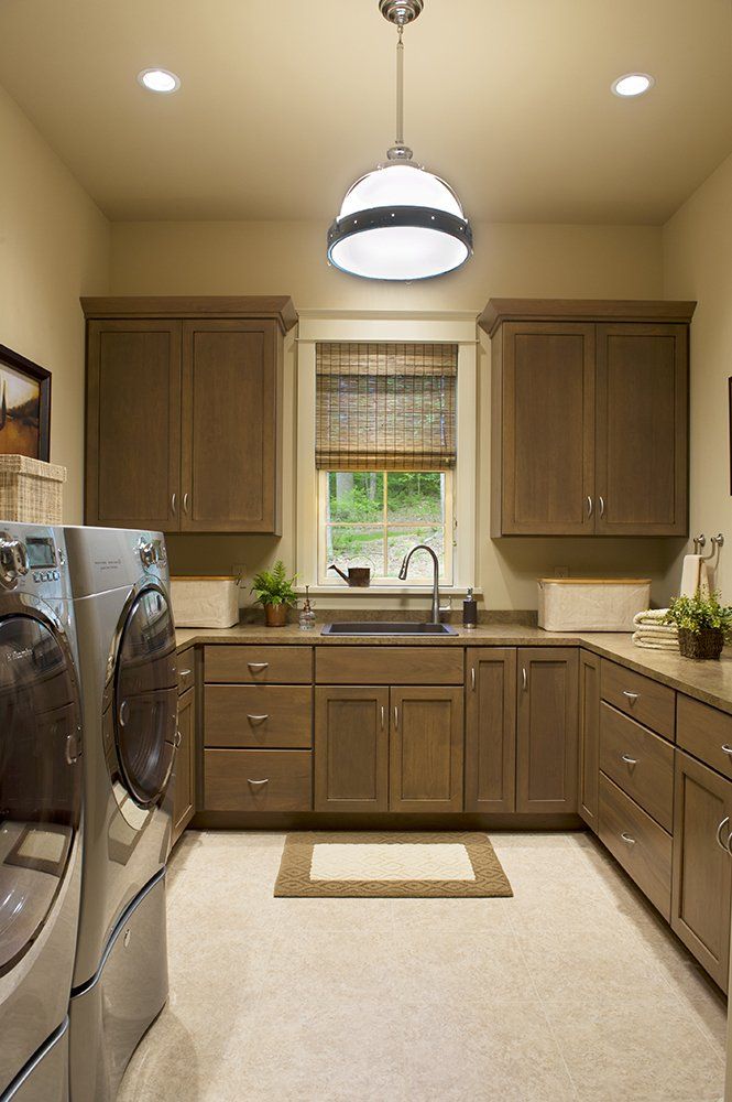 A laundry room with a washer and dryer and a sink