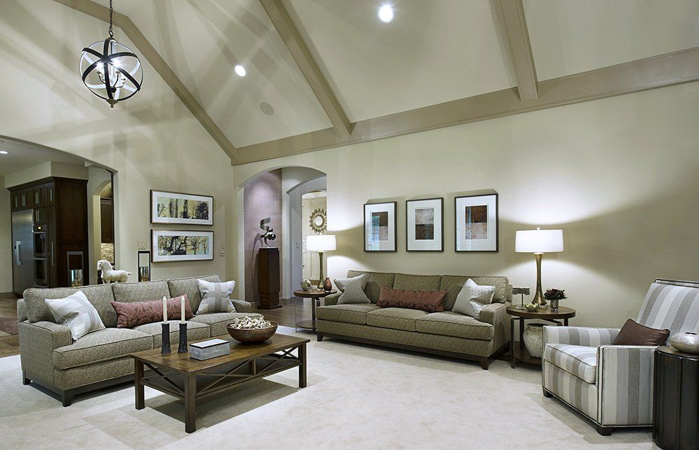 A living room with a vaulted ceiling and lots of furniture