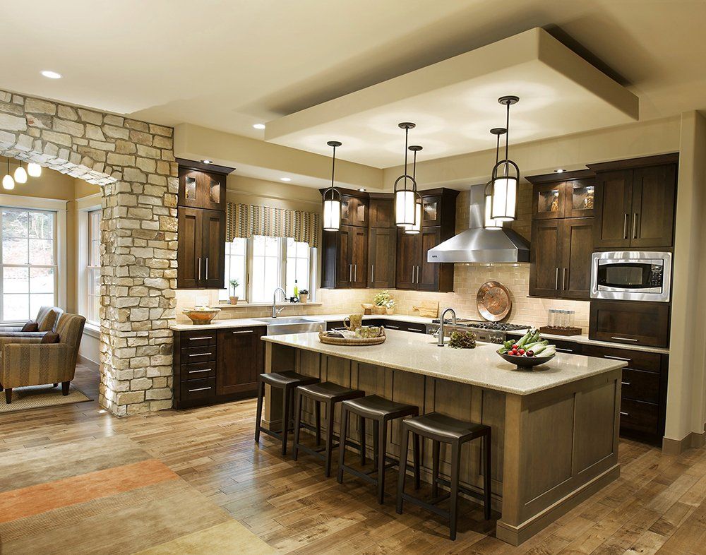 A kitchen with a large island and stools