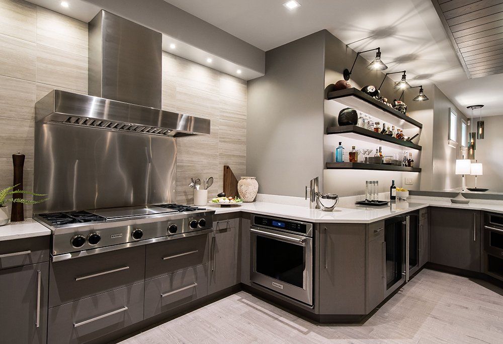 A kitchen with stainless steel appliances and a stove top oven