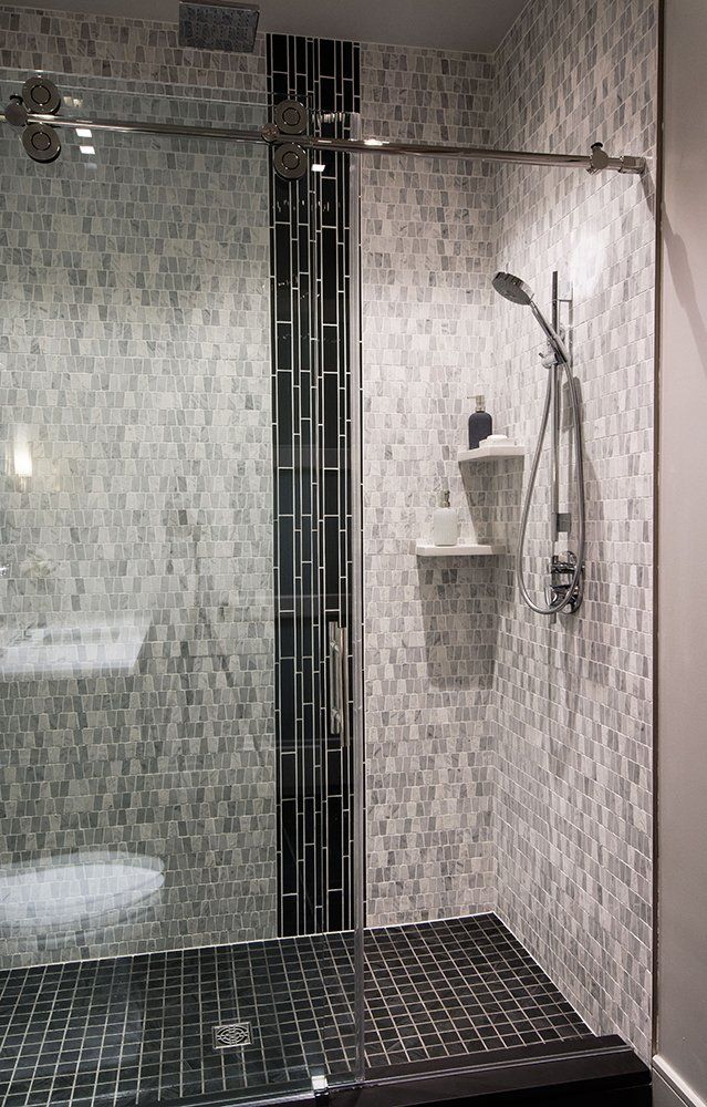 A bathroom with a walk in shower and a toilet.