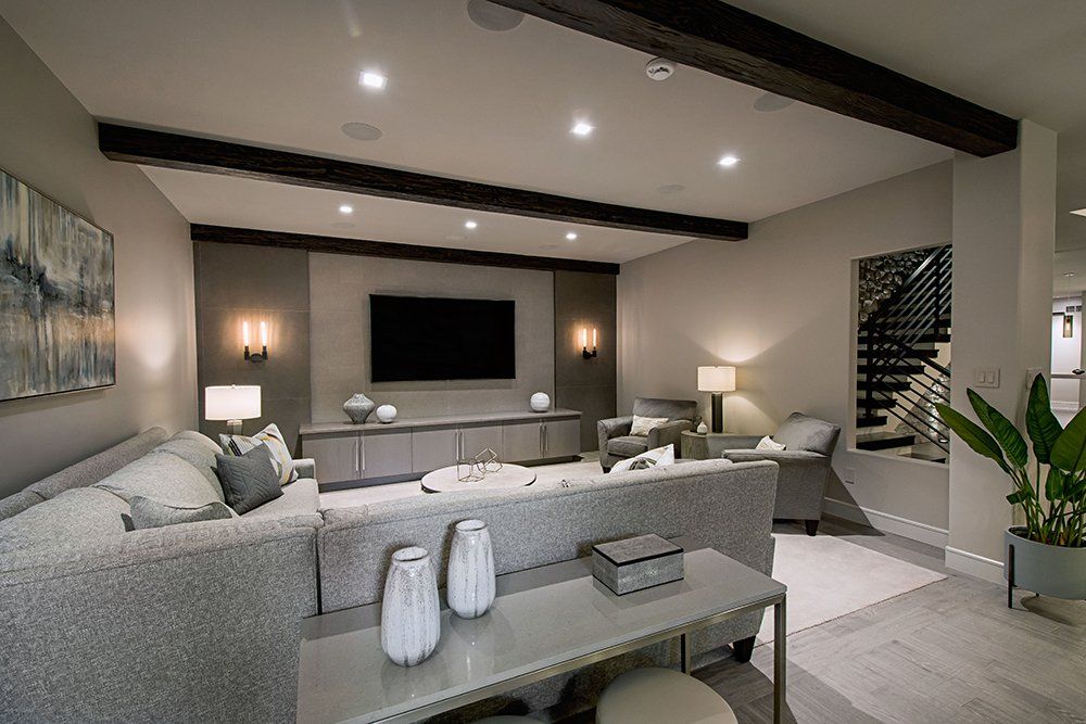 A living room with a large couch and a flat screen tv
