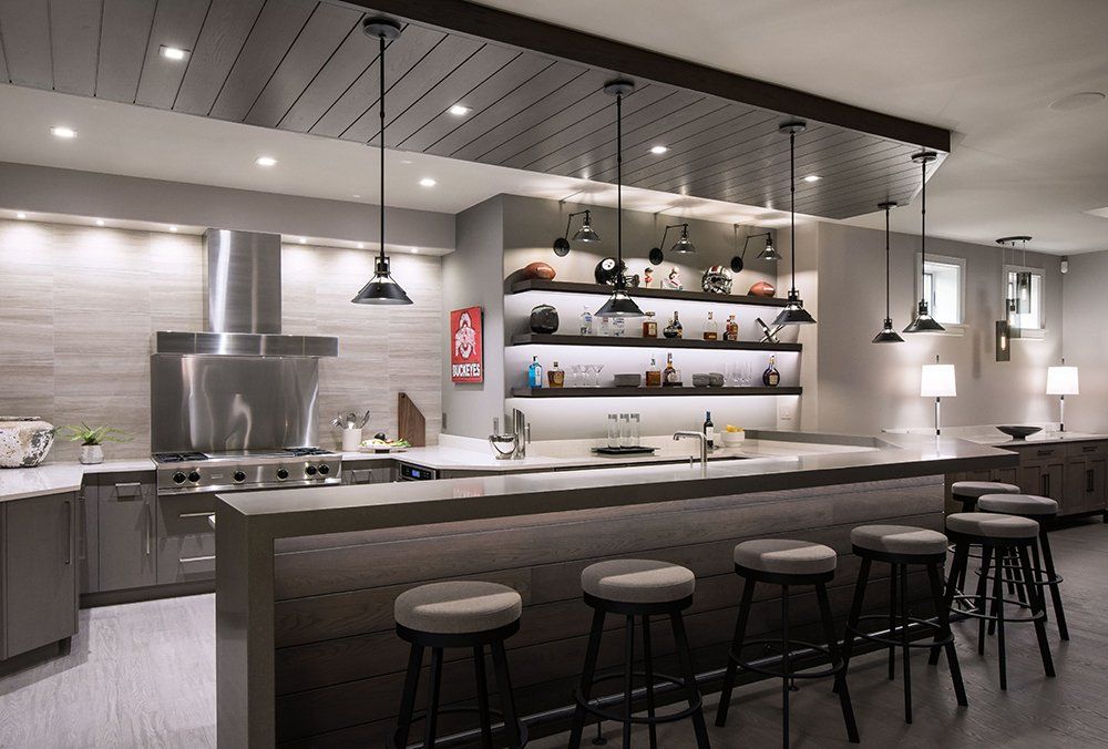 An artist 's impression of a kitchen with a bar and stools