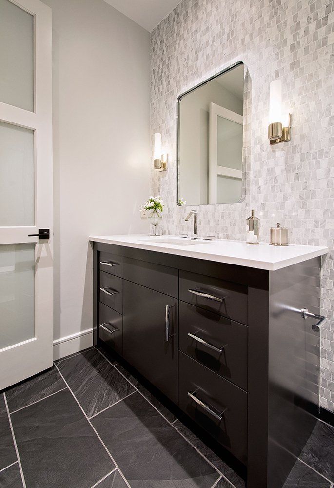 A bathroom with two sinks and a mirror