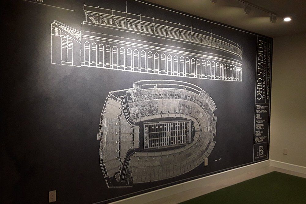 A black and white drawing of a stadium on a wall