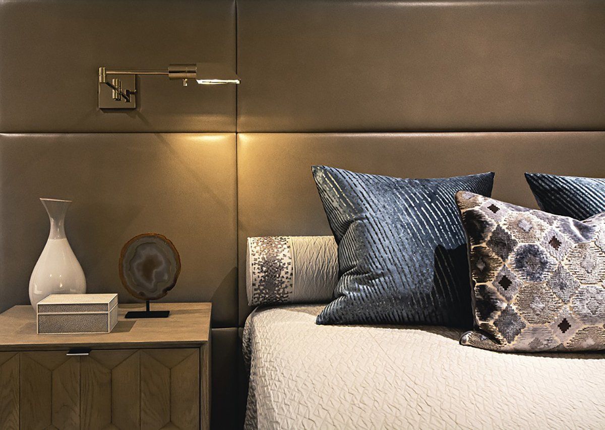 A bed with pillows and a nightstand next to it