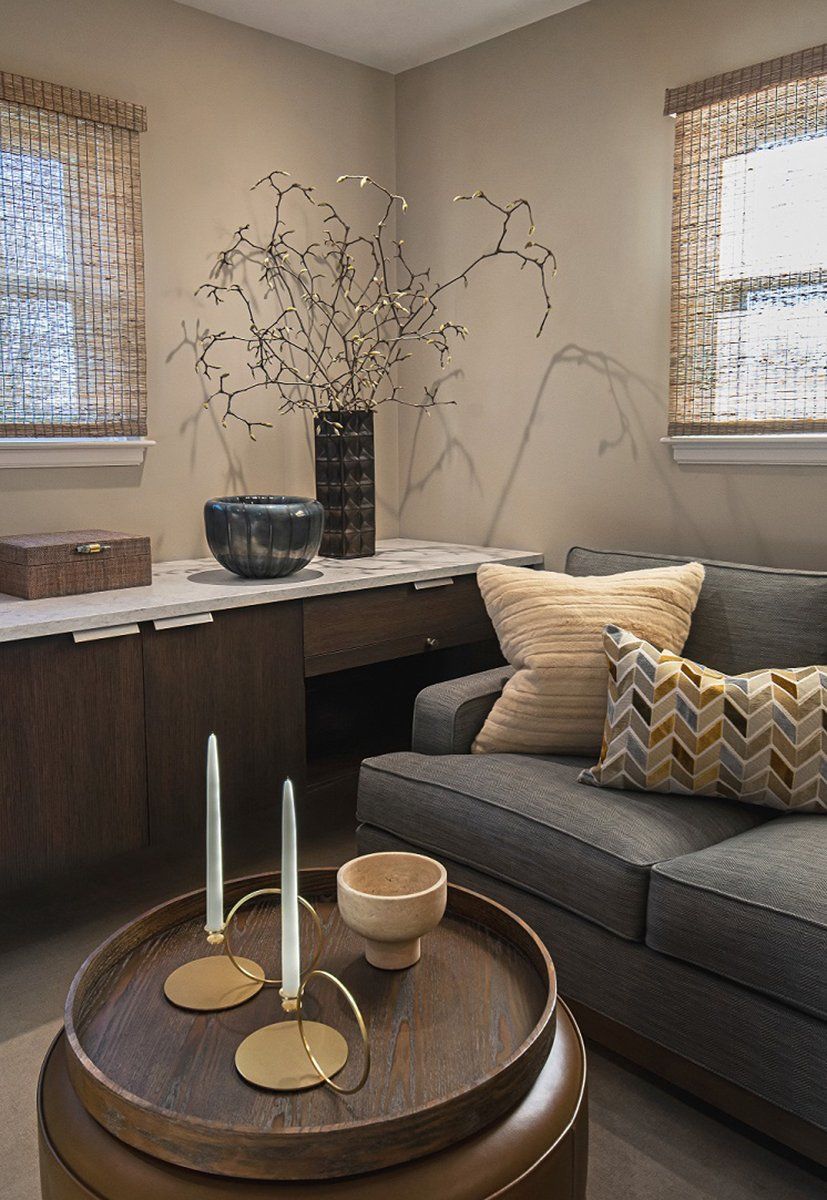 A living room with a couch and a table with candles on it
