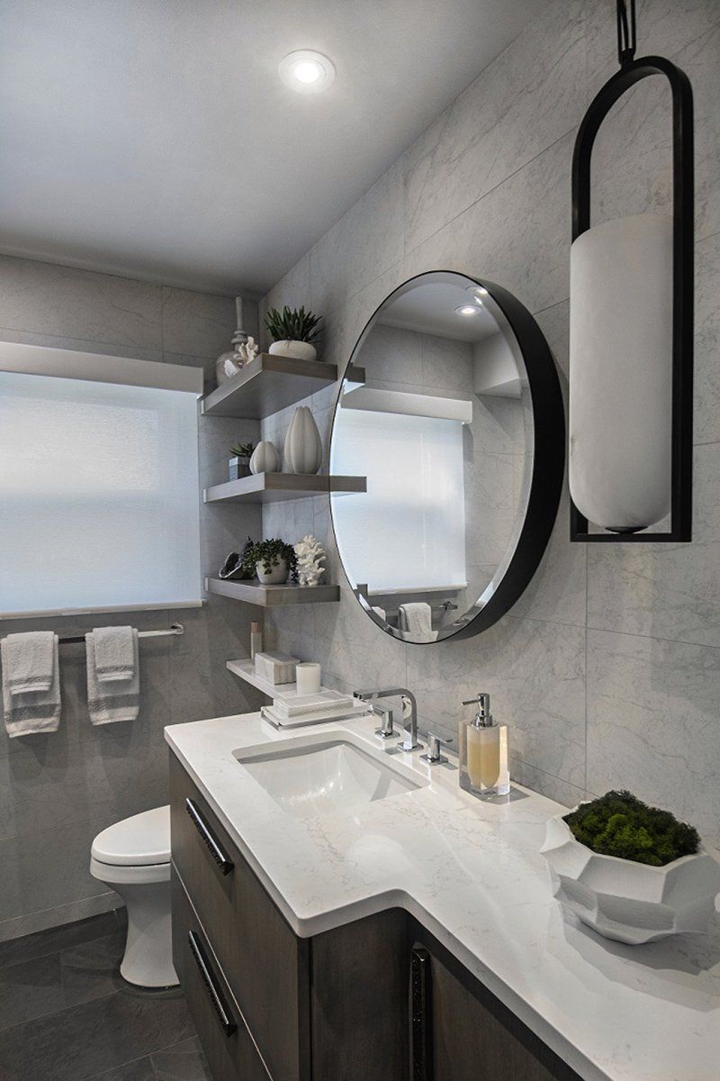 A bathroom with a sink , toilet and mirror