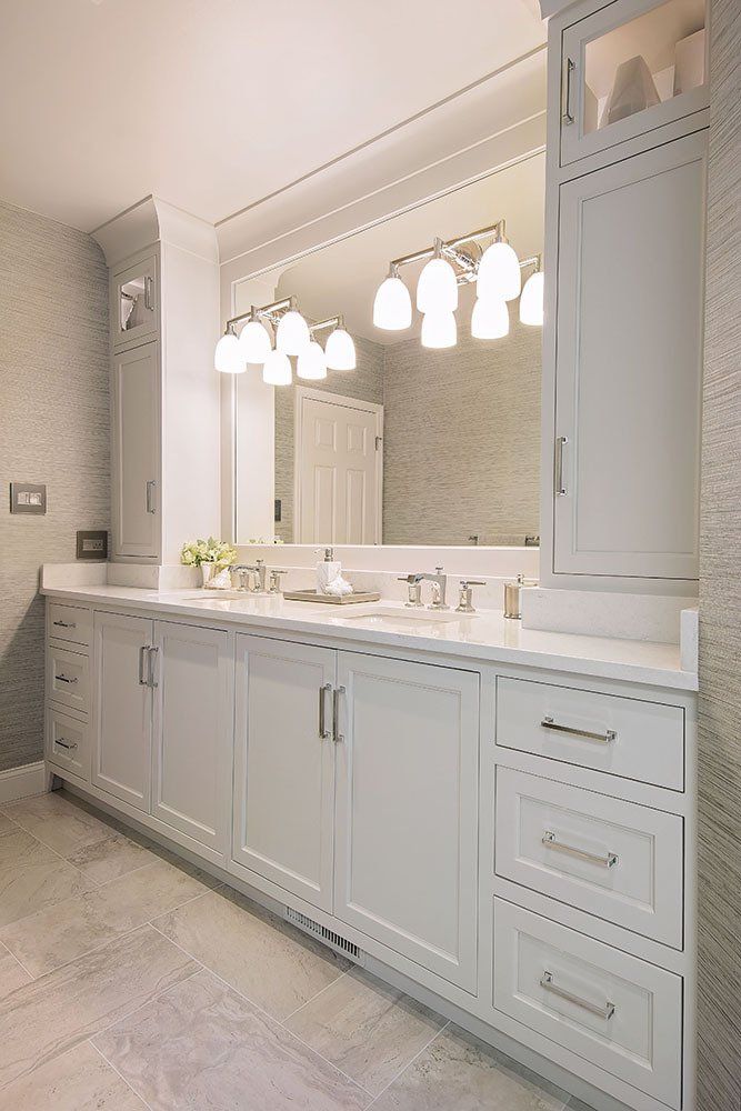 A bathroom with two sinks and a large mirror