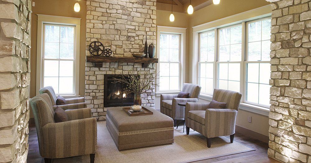 A living room with brick walls and a fireplace