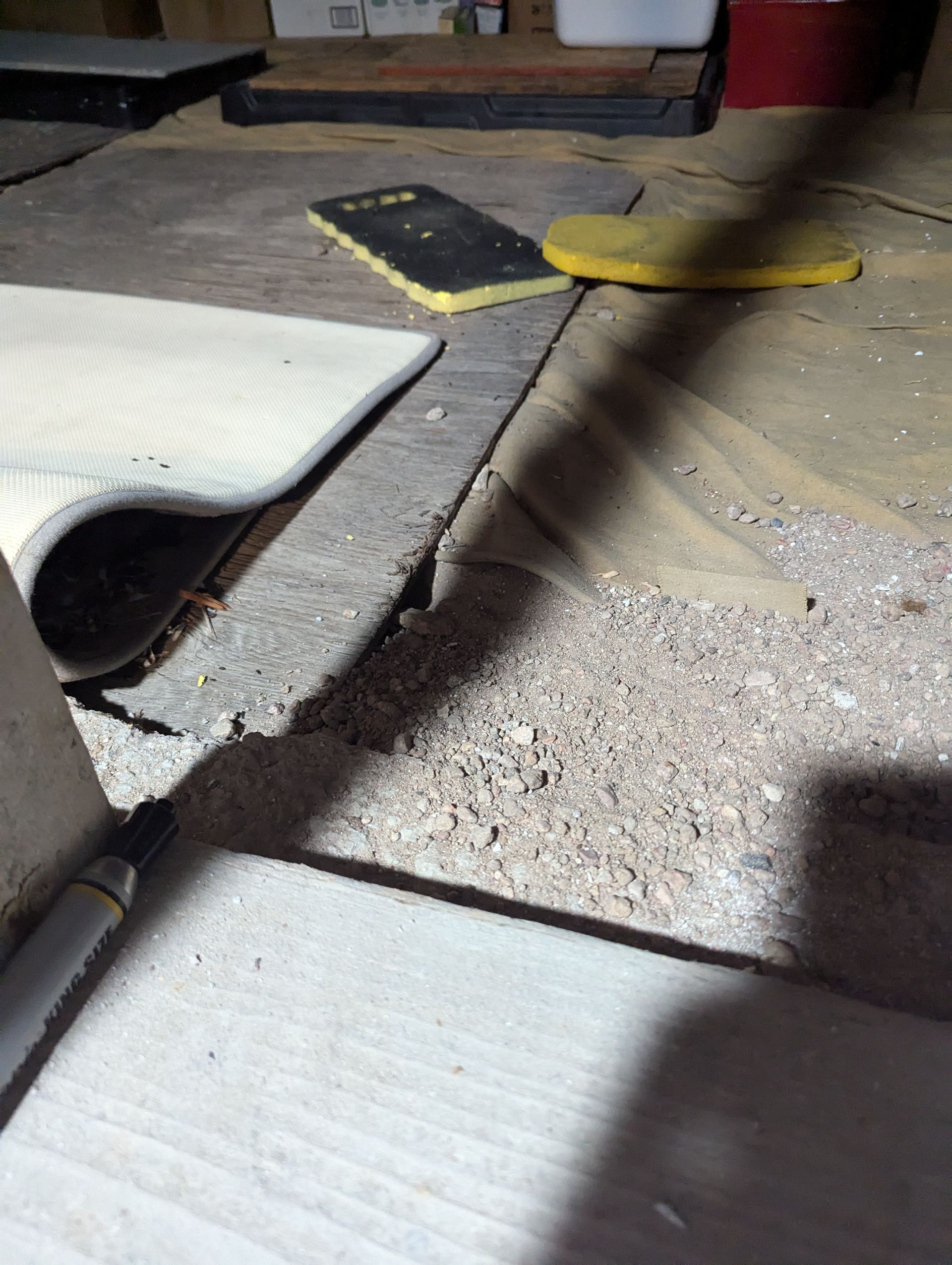 A close up of a tile floor with a yellow sponge on it.