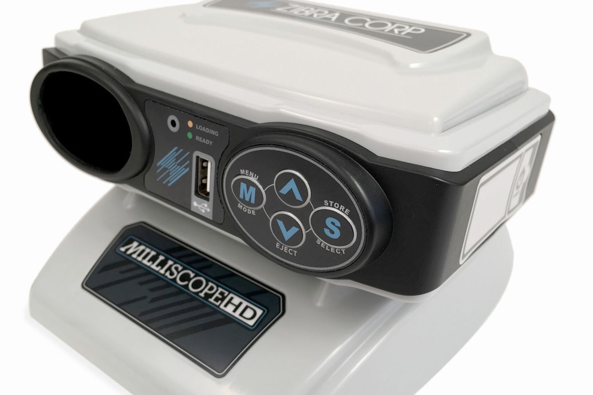 A hillscope hd device is sitting on a white surface