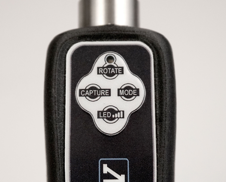 A close up of a remote control that says rotate capture mode and led on it