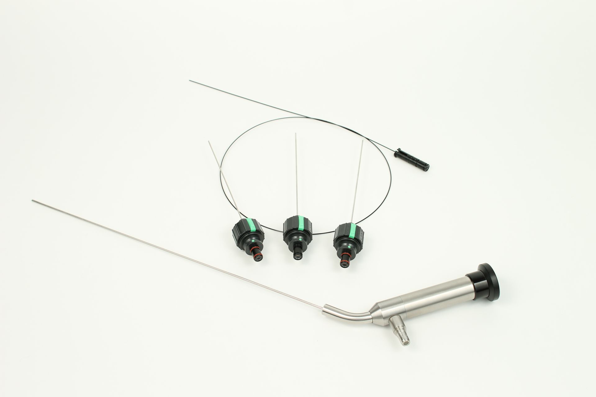 A pair of ear buds and a surgical instrument on a white surface