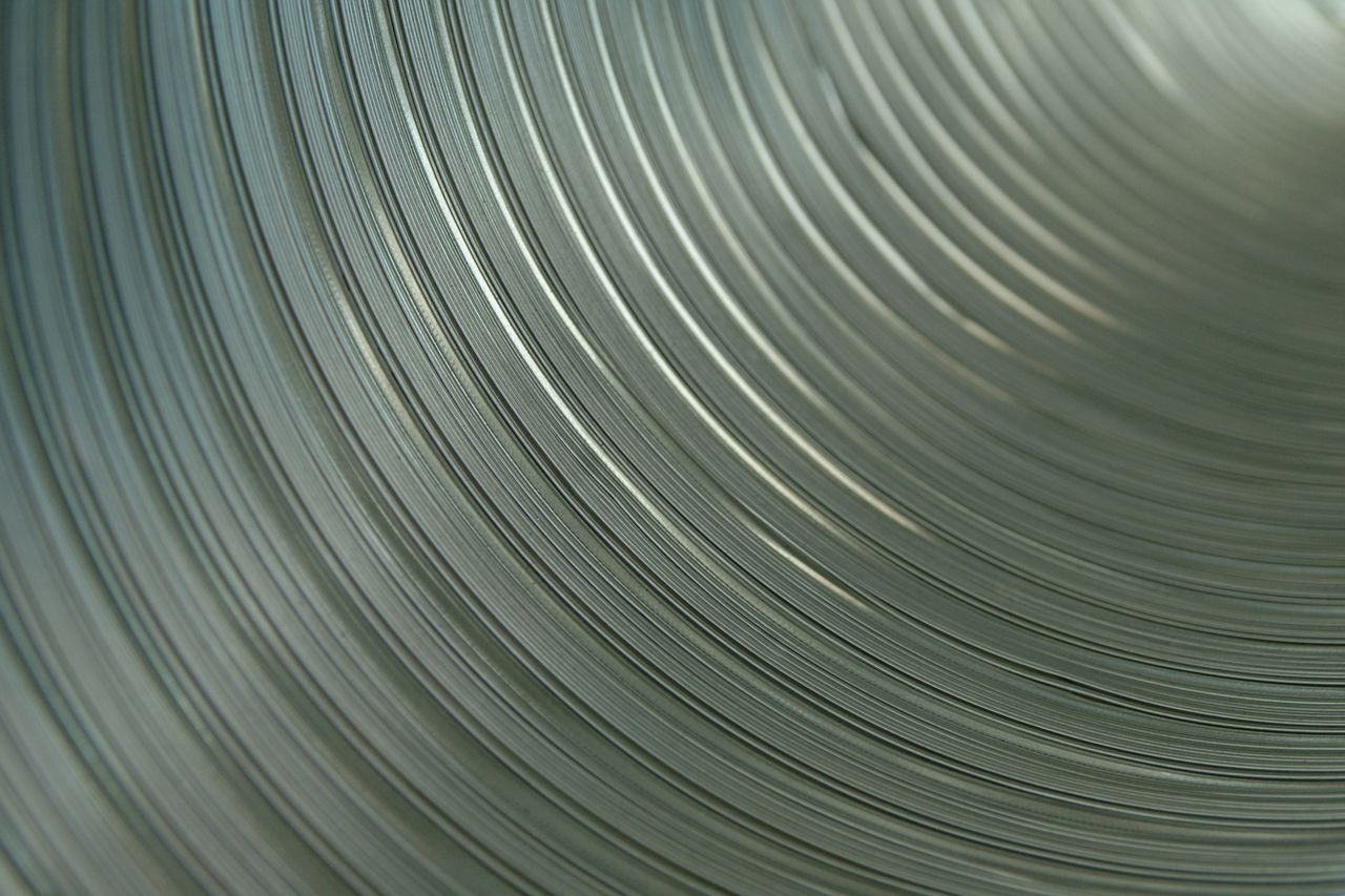 A close up of a metal pipe with a circular pattern