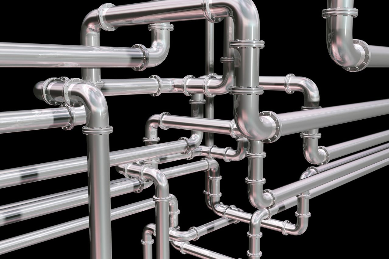 A bunch of metal pipes are connected to each other on a black background.