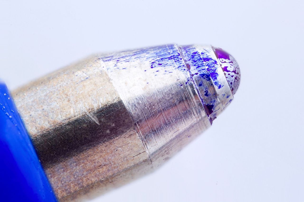 A close up of a pen with purple ink on it