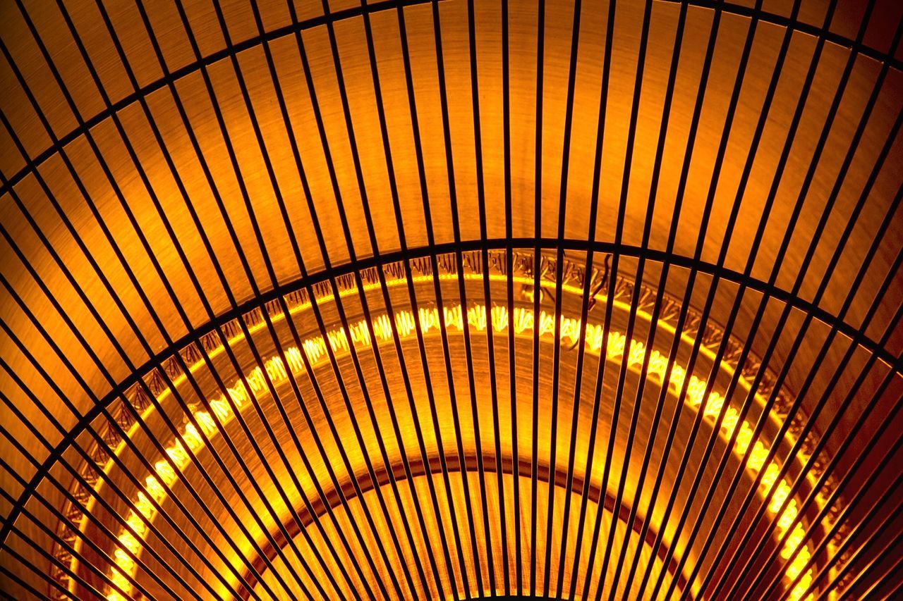 A close up of a fan with a yellow light coming out of it