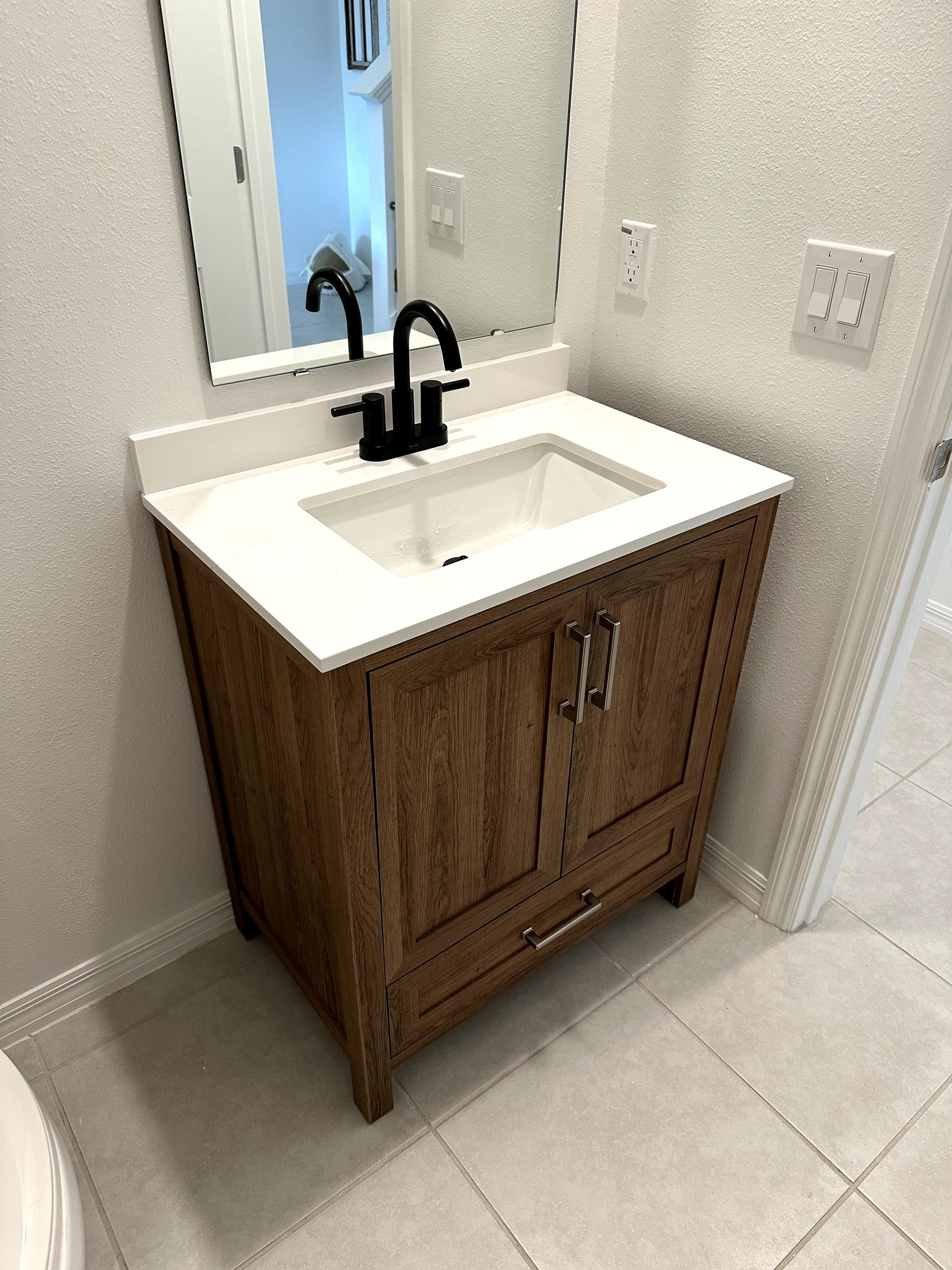 A bathroom vanity with a sink and a mirror.