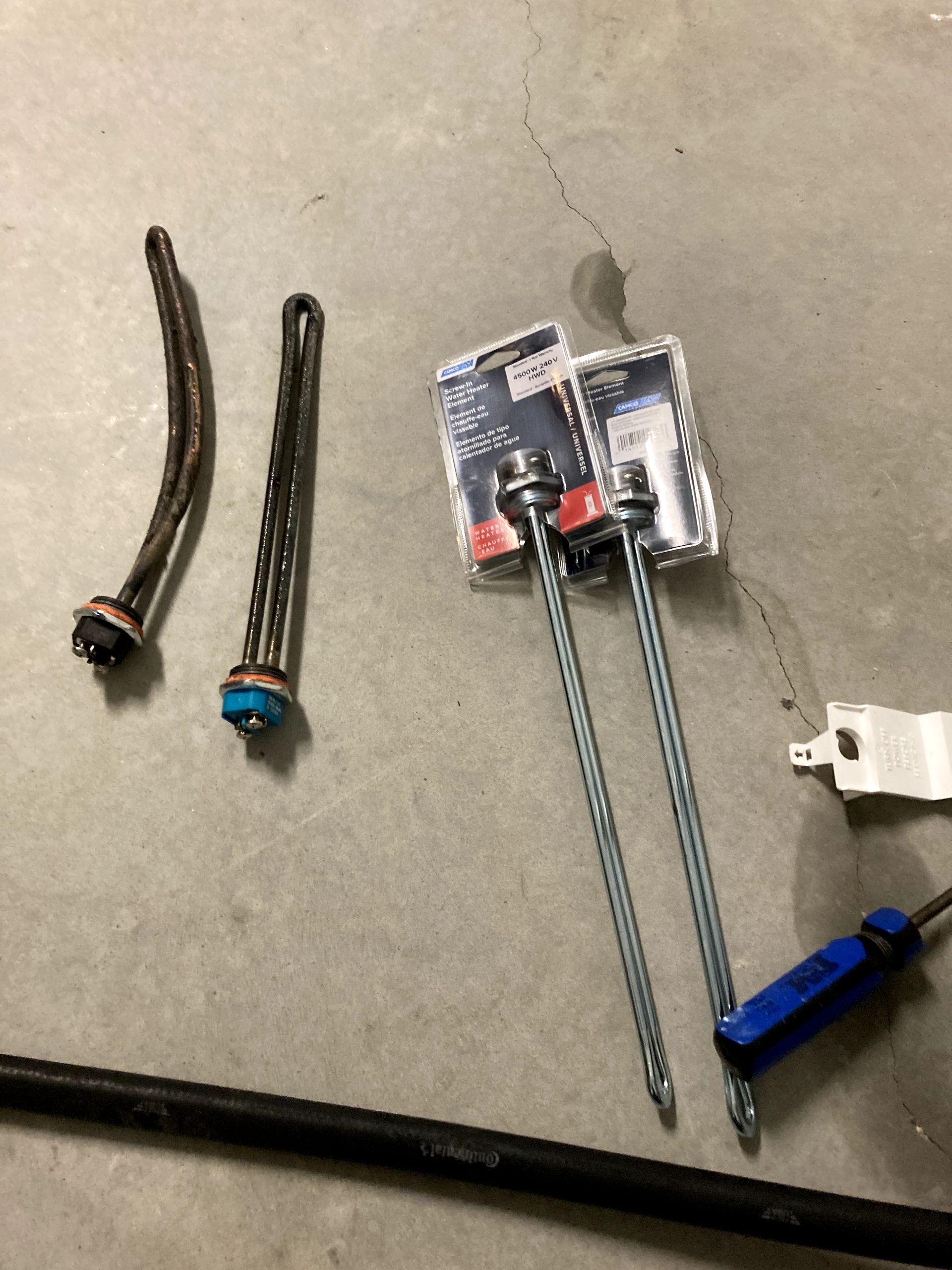 A bunch of tools are sitting on a concrete floor.