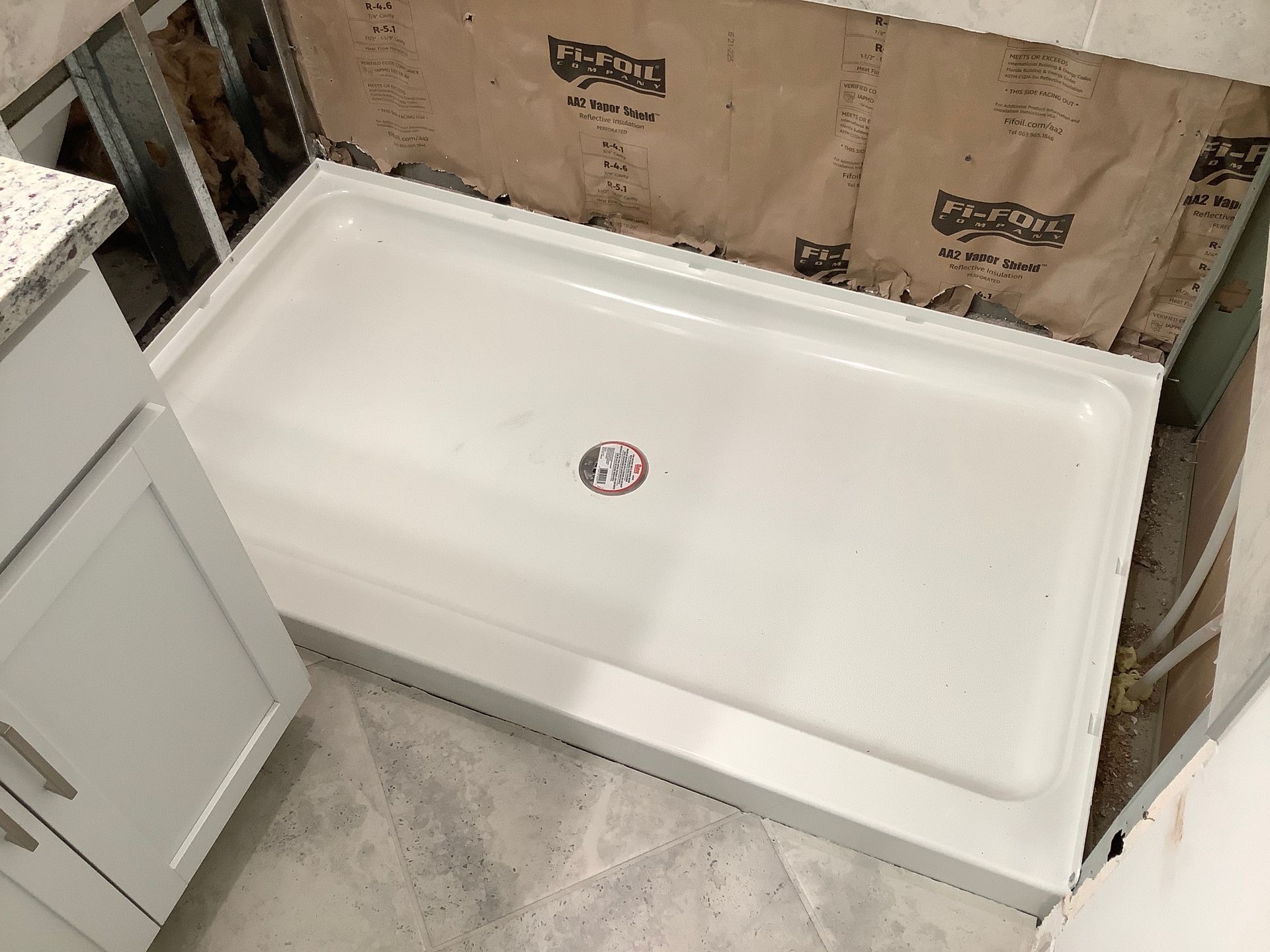 A shower stall is being built in a bathroom.