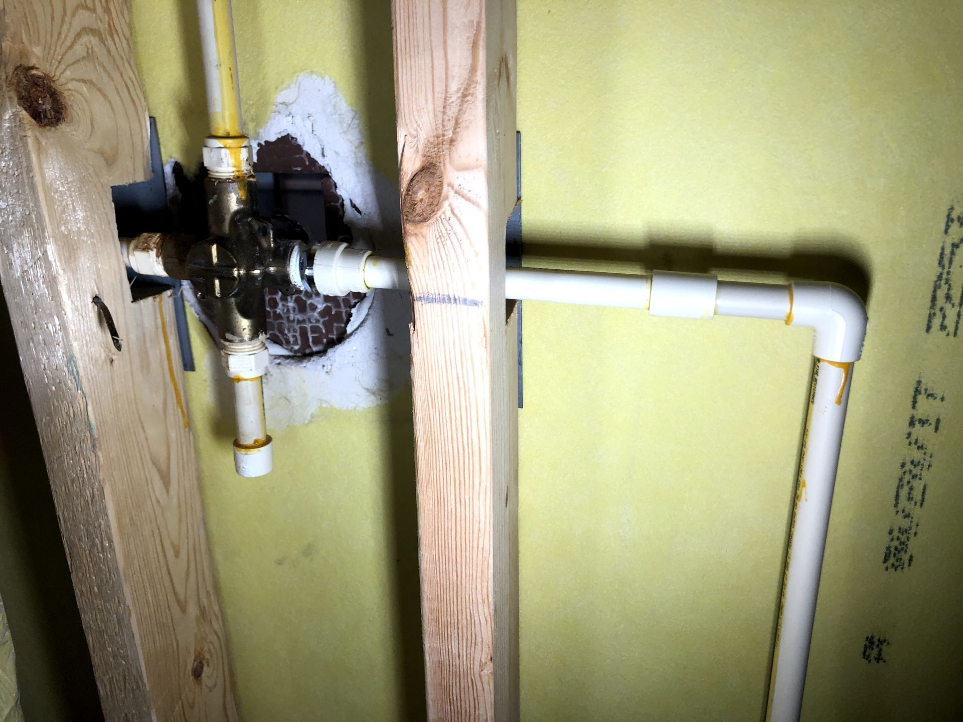 A close up of a pipe in a wall that says ' a ' on it