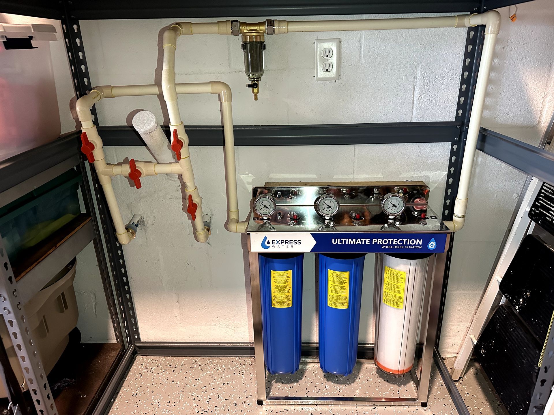 A water filter is sitting under a shelf in a room.