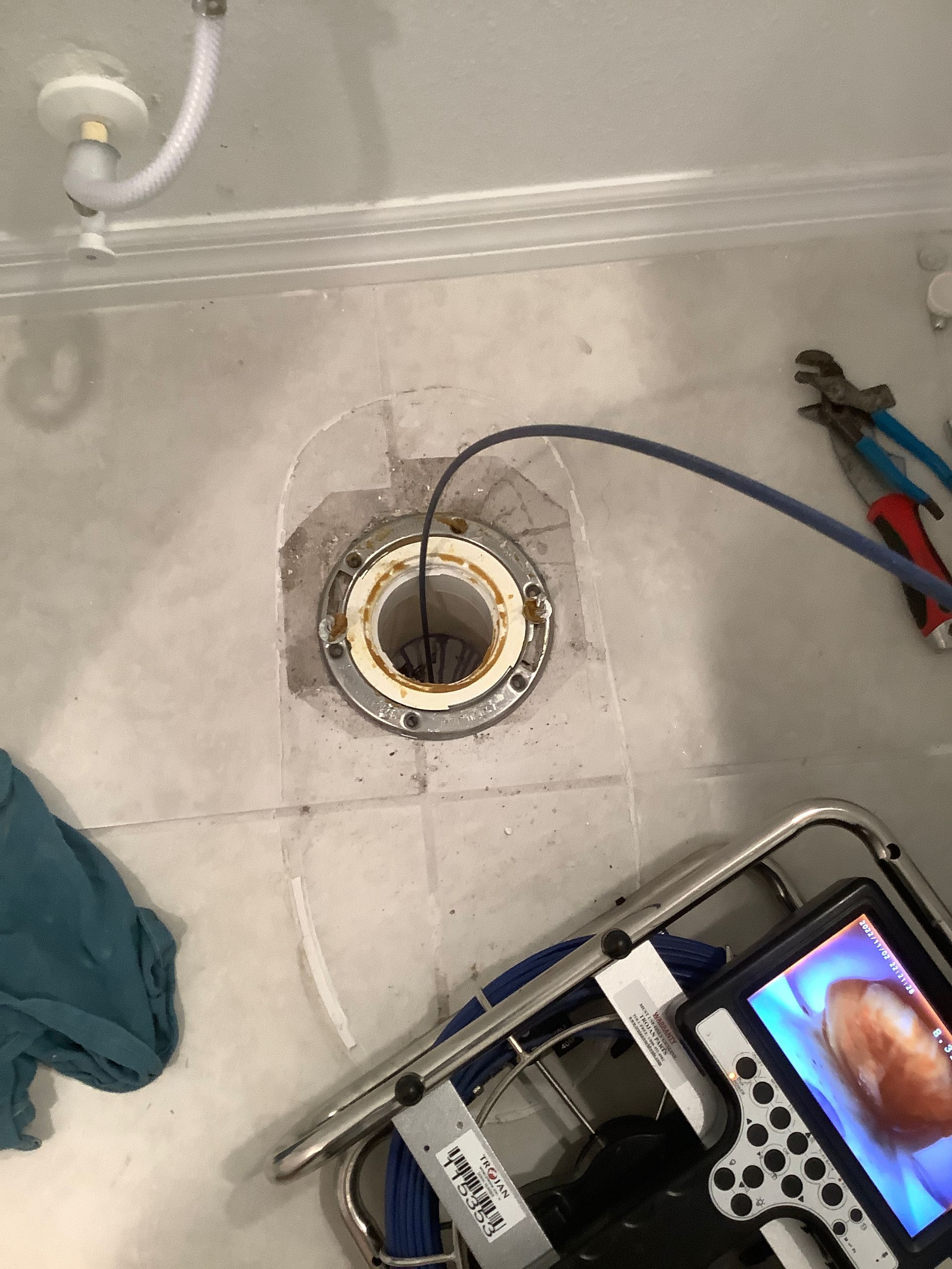 A camera is being used to look into a drain in a bathroom