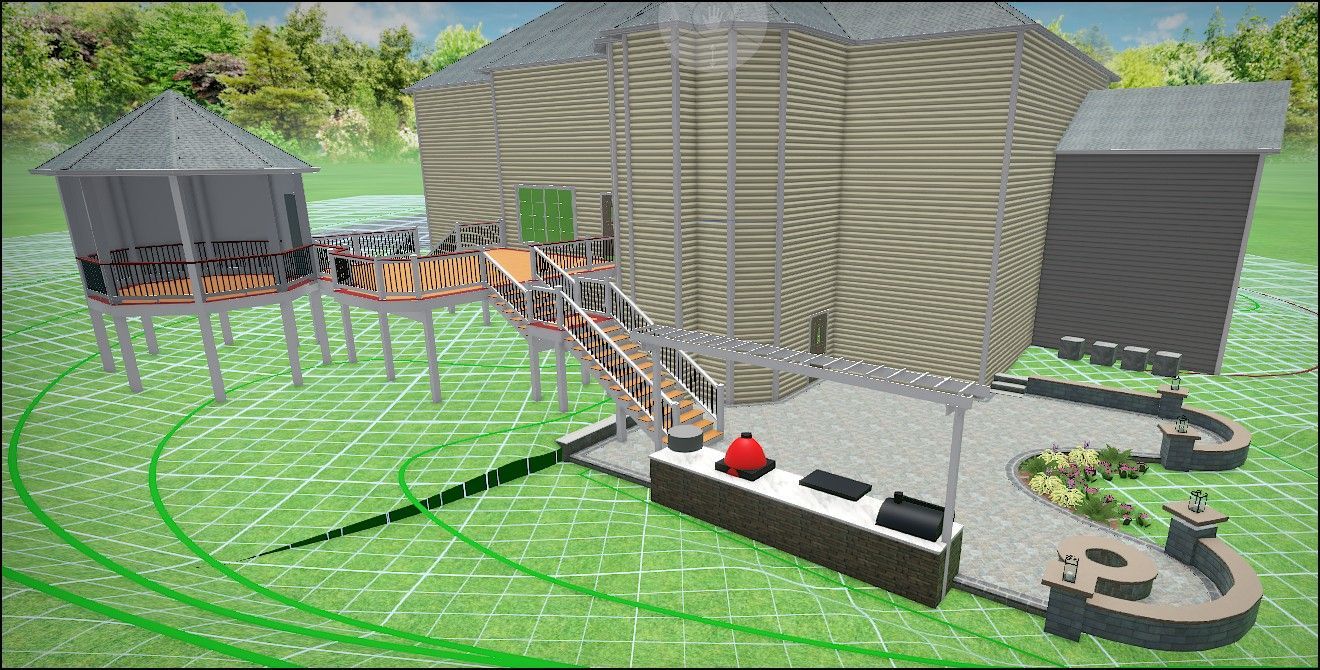 Elevated wooden structure with a ramp and stairs leading to a large building, surrounded by green grass.