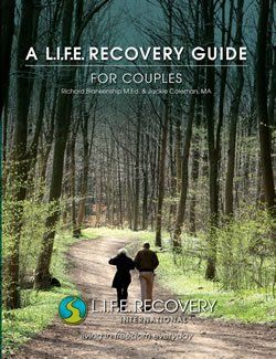 A life recovery guide for couples shows a man and woman walking down a path in the woods.