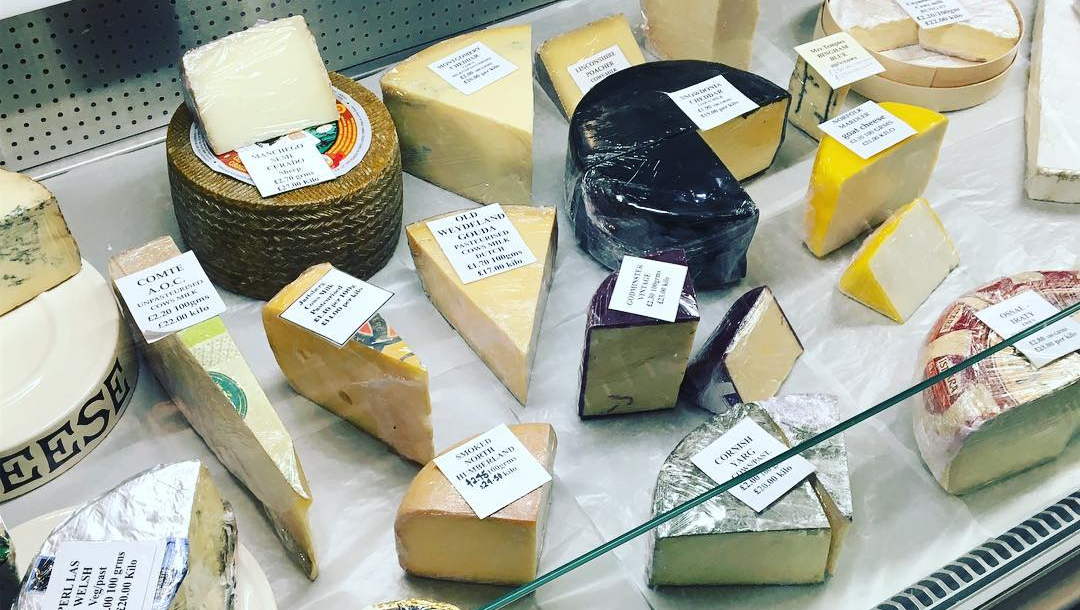 case of cheese blocks and wedges with price tag labels