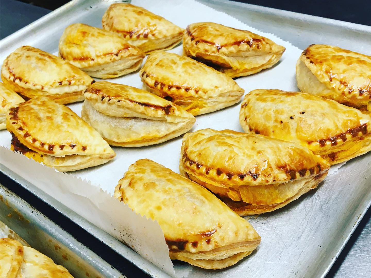 deli baked goods pies on baking sheet with wax paper