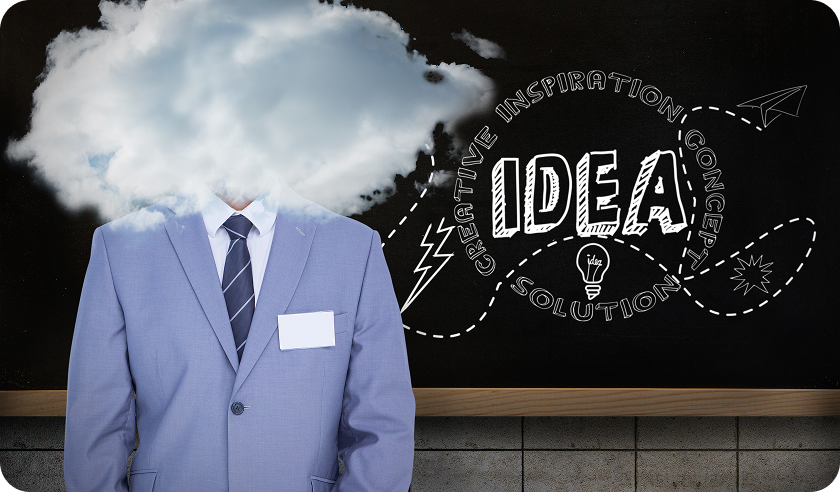 A man in a suit has a cloud coming out of his head and the word idea written on a blackboard behind him