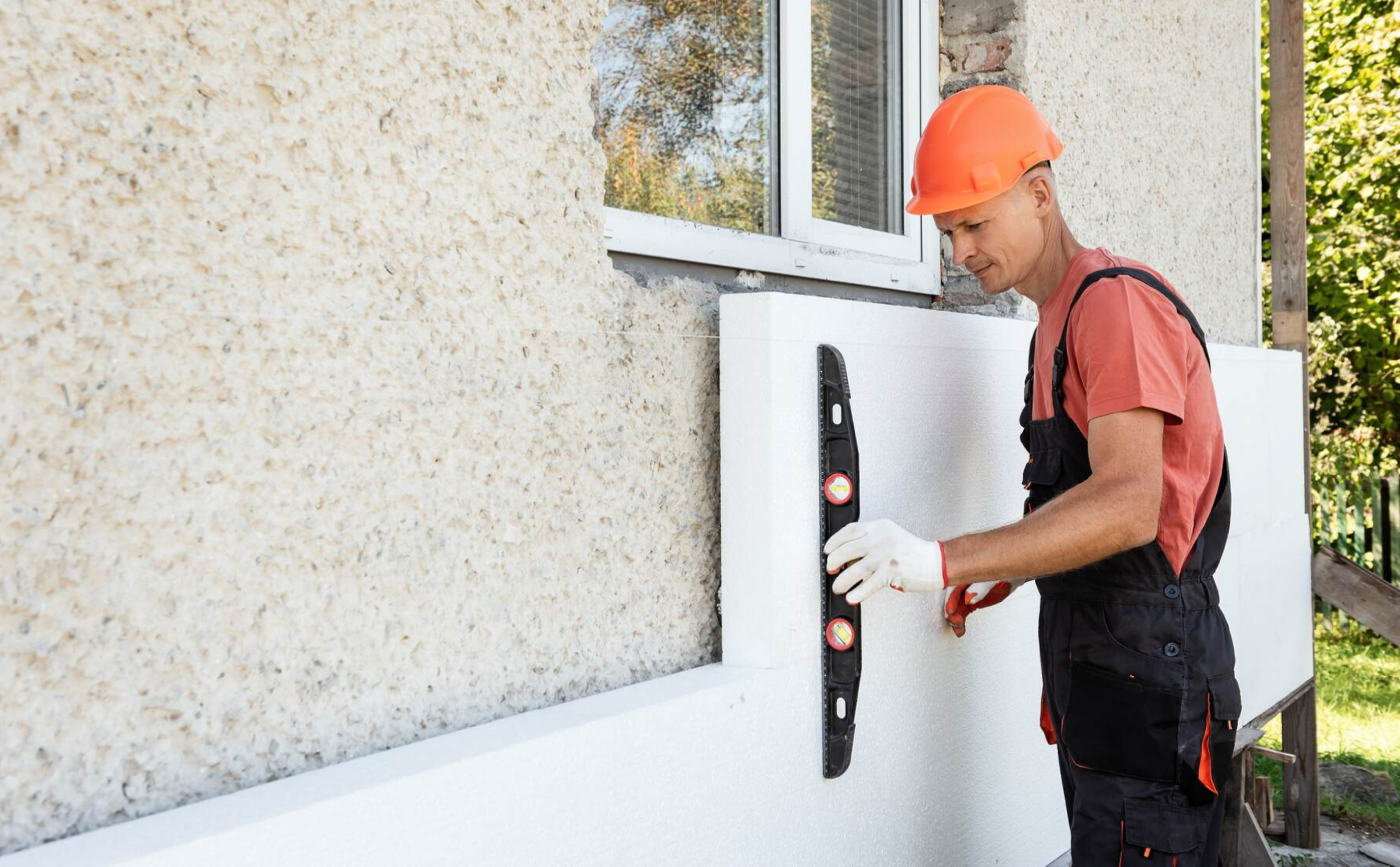 man applying external wall insulation