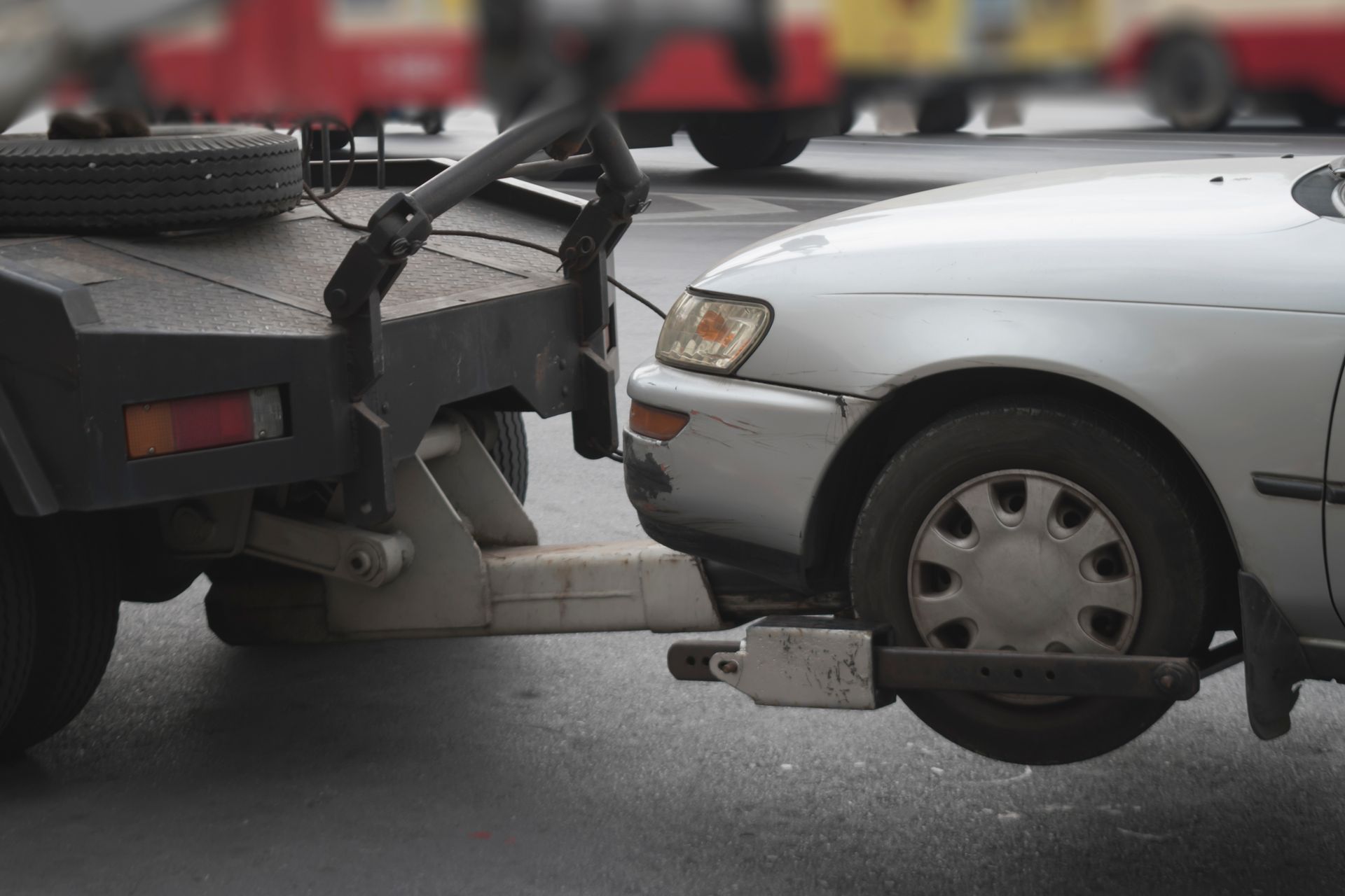 A car is being towed by a tow truck.