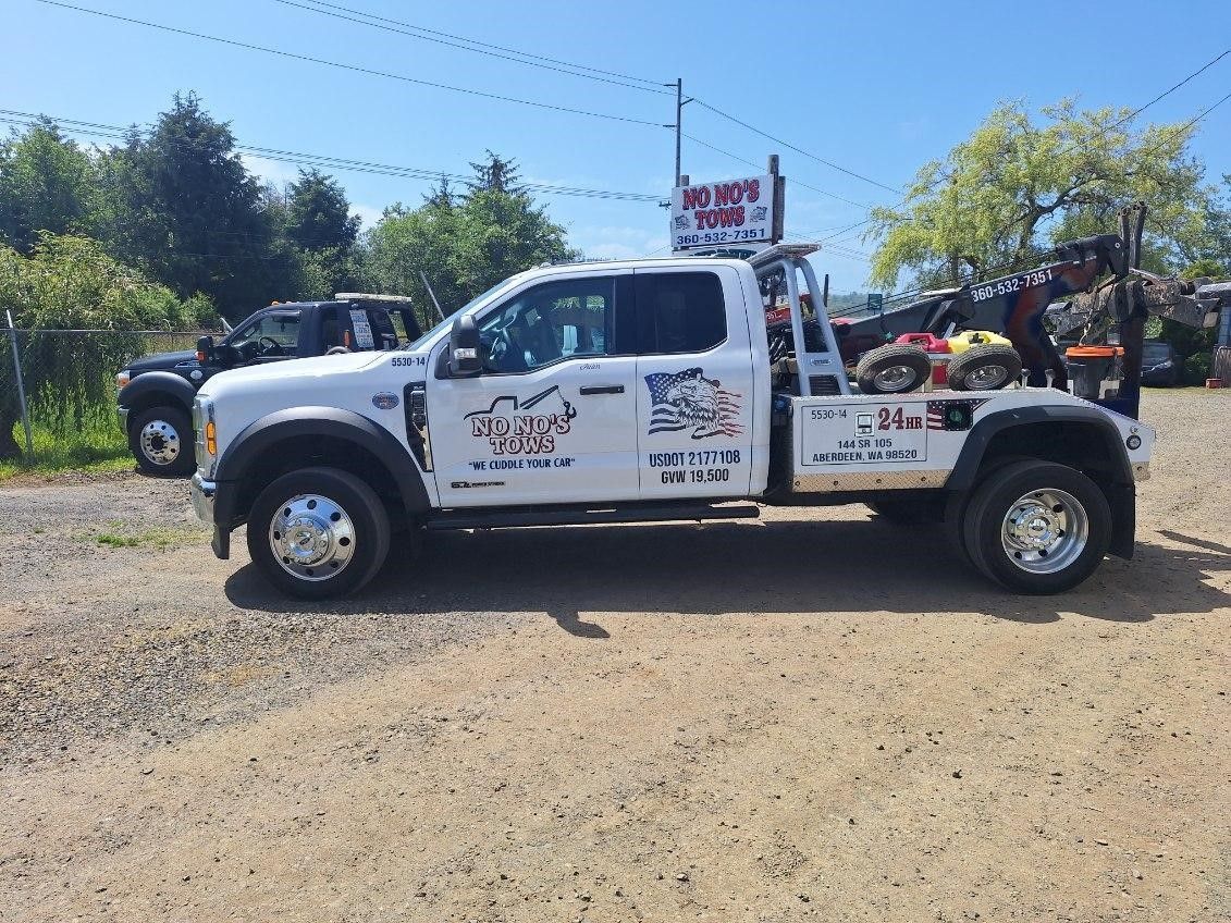 A car is being towed by a tow truck.