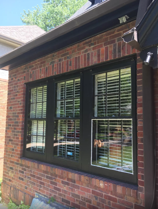 A large window on the side of a brick building.