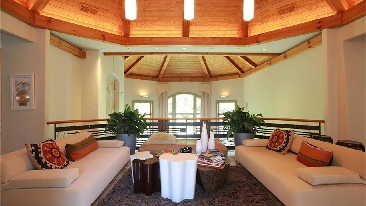A living room filled with furniture and a wooden ceiling