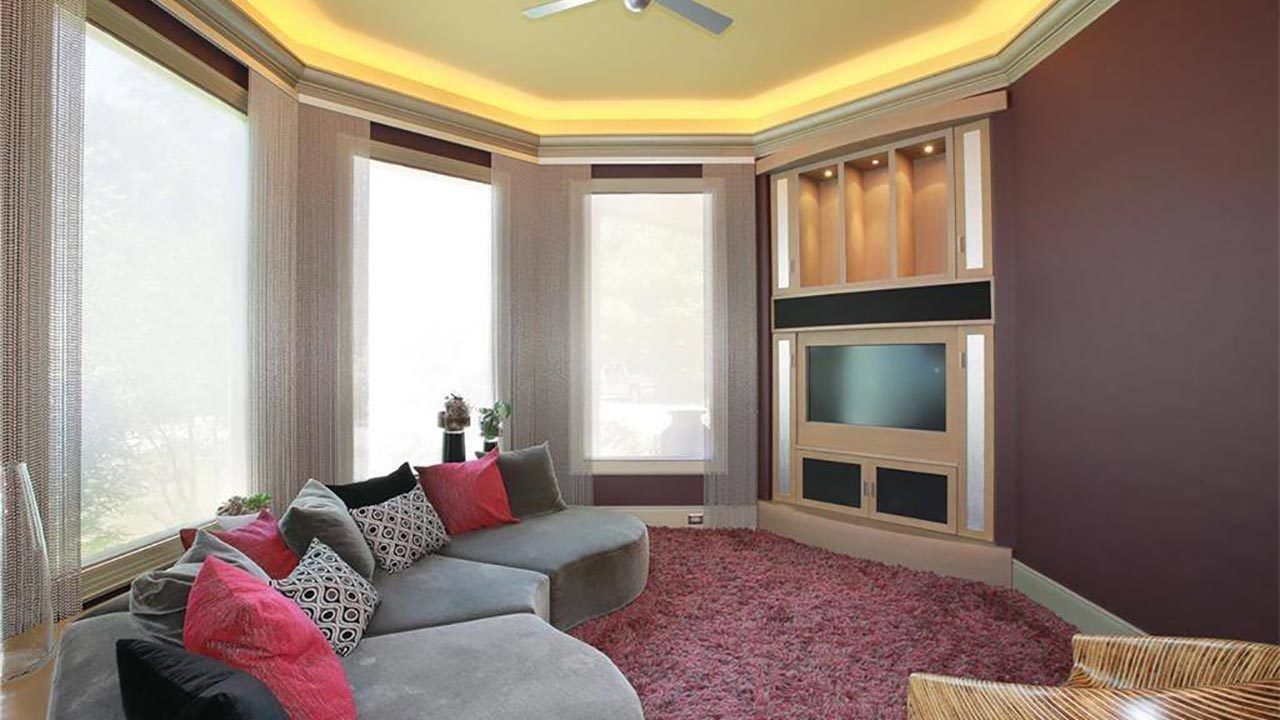 A living room with a couch , chair , and television.